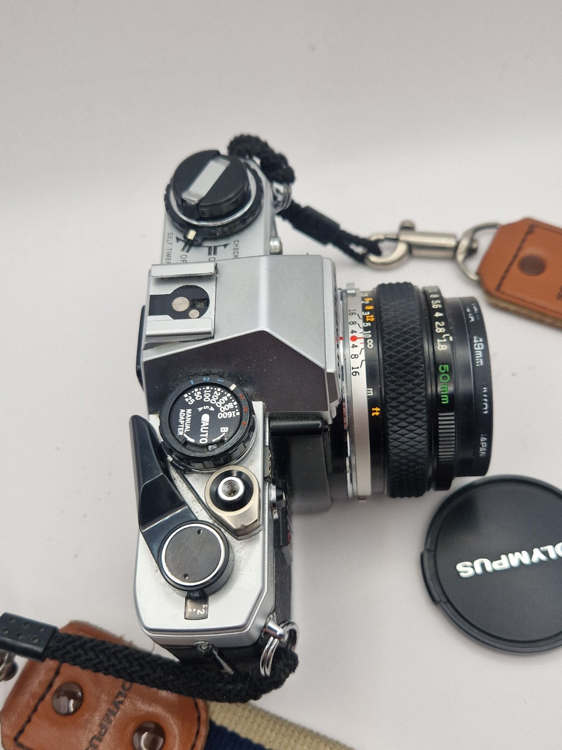 Toppvisning av Olympus OM-10 som viser kontrollhjul, filmfremtrekk og blitssko.