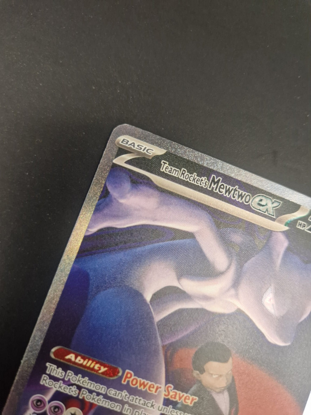 Nærbilde av øvre venstre hjørne på Team Rocket's Mewtwo ex 281/217