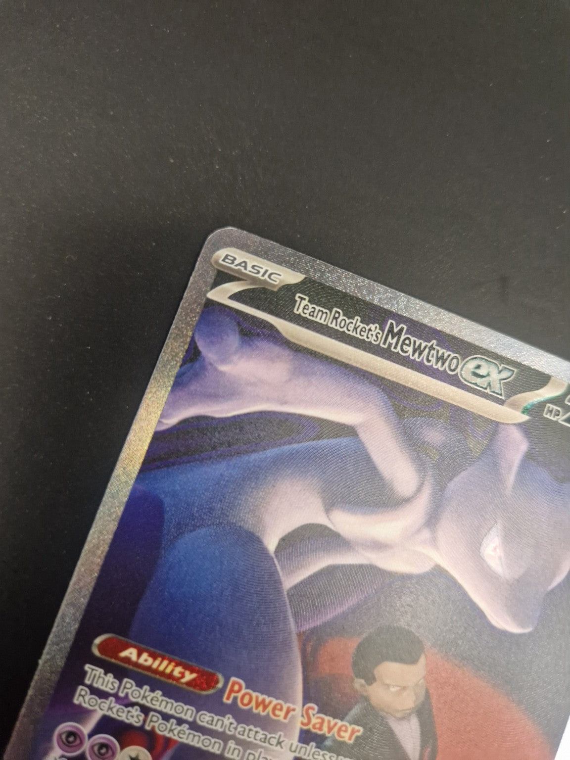 Nærbilde av øvre venstre hjørne på Team Rocket's Mewtwo ex 281/217