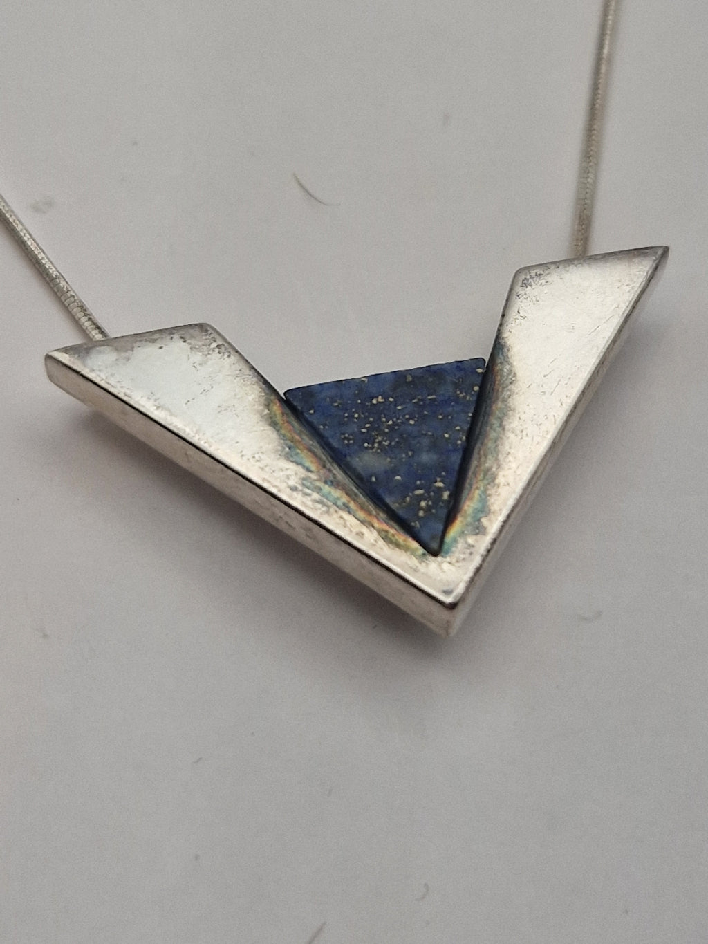 Nærbilde av anheng og blå stein